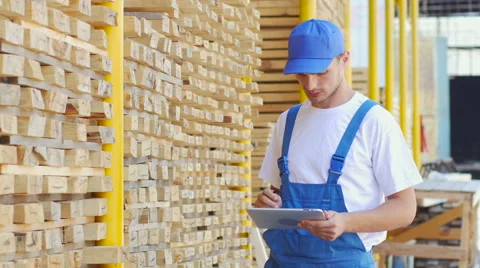 Employee of construction shop writes figures with a marker on wood Stock Footage 57096841
