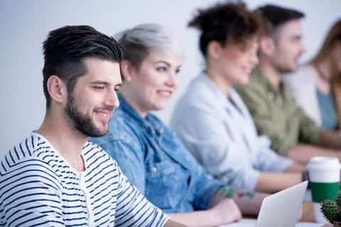 Employee cooperating with friendly team Stock Photos