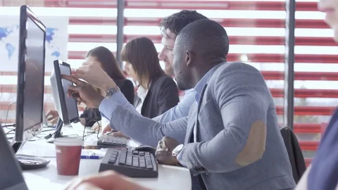 Employee discussing data on the computer with a partner Stock Footage 74291747