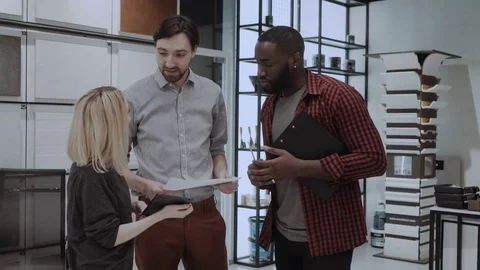 Employee discussing the project in the office. Multi ethnic coworkers. In Design Stock Footage 84708479