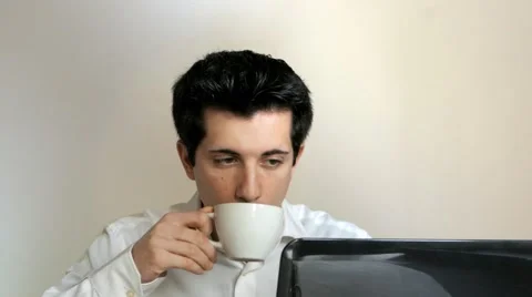 Employee drinking cup of coffee in front of the pc Stock Footage 61503098