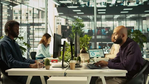 Employee editing documents on desktop computer at office desk Stock Footage 305772045