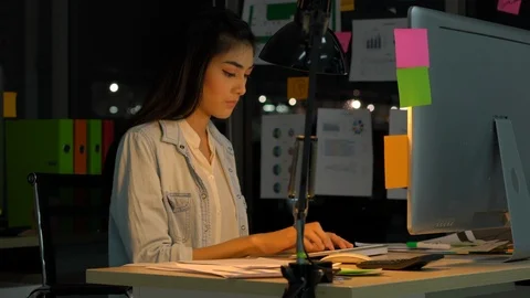 Employee female hard working with computer to late night at office. Stock Footage 106864892