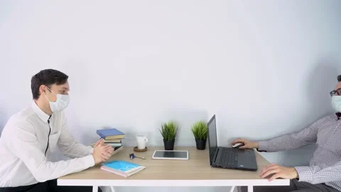 Employee forgetting about precautions, gives hand for shaking, but guy refuses. Stock Footage 131470004
