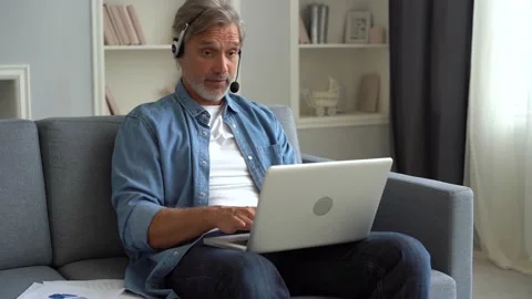 Employee of helpline technic support helps to client distantly through videocall Stock Footage 139751646