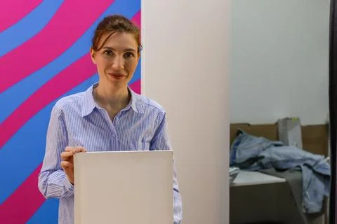 Employee holding empty white panel in order pickup room Stock Photos