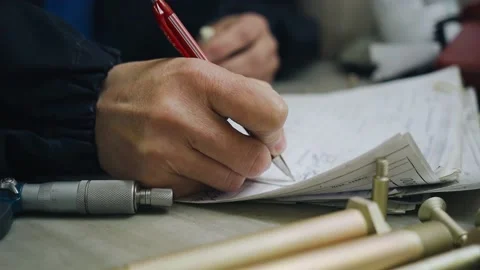 The employee makes notes about the measurement results in a notebook Stock Footage 155211109