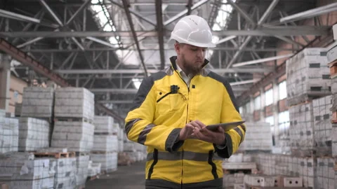 Employee male warehouse worker engineer man in hard hat working at construction Stock Footage 114472985