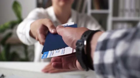 An employee manager agent issues tickets for a flight, air travel coupons fo Stock Footage 201438380