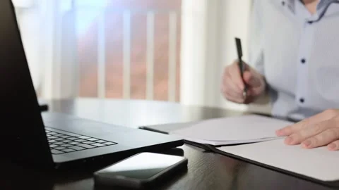 An employee in an office signs documents. Stock Footage 306320908
