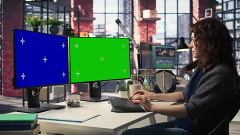 Employee in office working on PC with isolated copy space on dual monitors Stock Footage 308603324