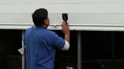 Employee opens truck loading hatch Stock Footage 77053436