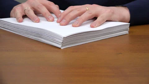 An employee pushes a stack of documents and puts a pen to sign Stock Footage 99937976