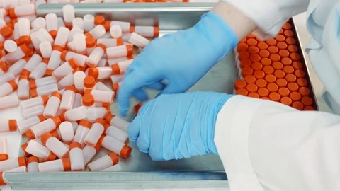 Employee puts plastic containers with liquid Stock Footage 101013617