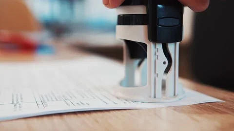 The employee puts a stamp on the documents 스톡 동영상 163290241