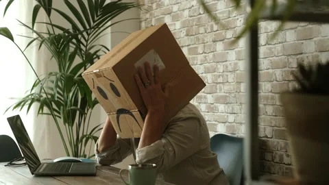 Employee with a sad face cardboard box on their head feeling desperate Stock Footage 344397962