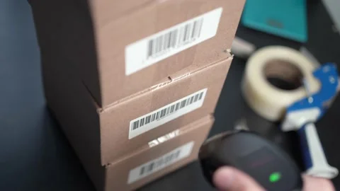 Employee Scanning the Bar Code Label on Shipping Boxes Stock Footage 185116864