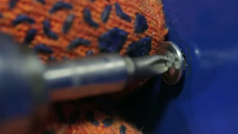 Employee screw is screwed in using a wireless electric screwdriver. The worker i Stock Footage 199486778