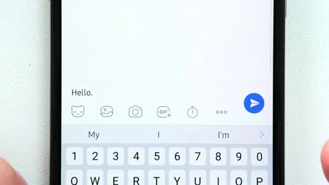 An employee sends a message to his supervisor on a smartphone "Hello. I overslep Stockbeeldmateriaal 248028812