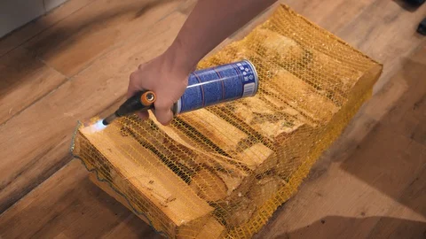 Employee sets fire to net unpacking wood logs for burning Stock Footage 126951014