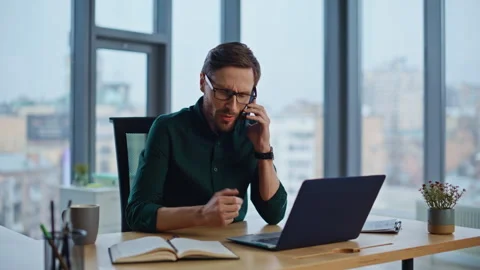Employee start cellphone conversation at light office closeup. Serious man Stock Footage 340237167