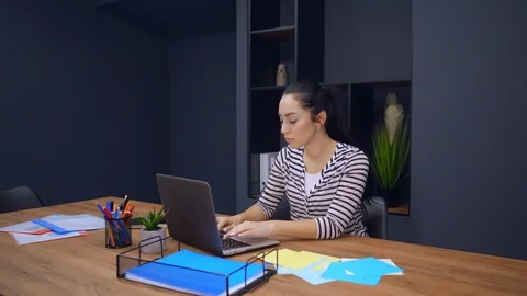 Employee in startup company smiling using laptop Stock Footage 113457792