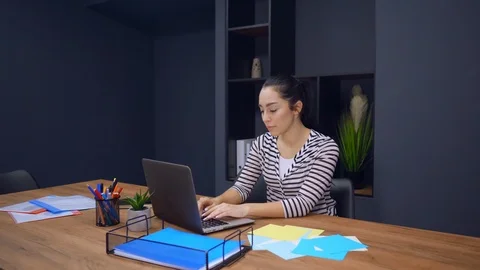 Employee in startup company use computer looks on the viewers Stock Footage 104836874