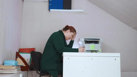 Employee struggles with printing issues. Worker deals with jammed printer and Stock Footage 345532775