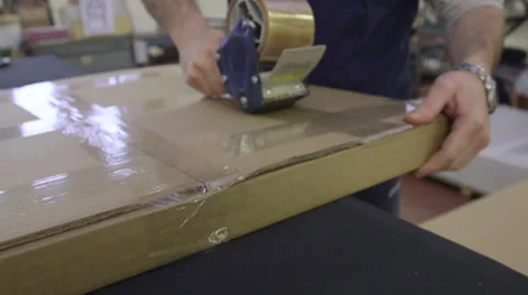 Employee taping box for shipping Stock Footage 46936571