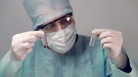 An employee of Tim's laboratory took two test tubes with various studies Stock Footage 130892000