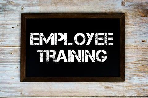 Employee Trainingtext written on blackboard flat lay on wooden background Stock Photos