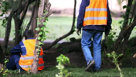 Employee in uniform walks around working place in city park Stock Footage 246053605