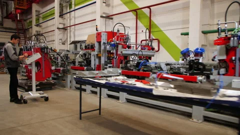 Employee uses control panel program production line at plant Stock Footage 163582159