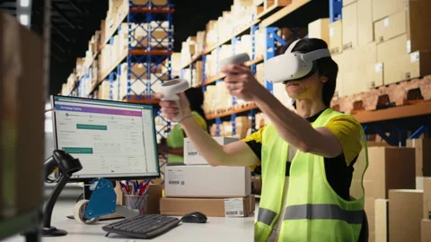 Employee uses virtual reality glasses to improve e-commerce operations Stock Footage 312836794