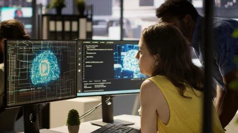 Employee using AI technology to design machine learning algorithms 写真素材