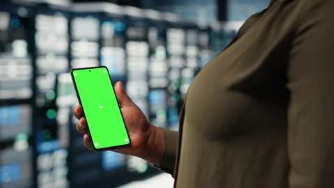 Employee using app on mockup phone to check server hub energy consumption. Stock Footage 317124885
