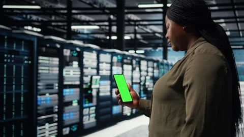 Employee using app on mockup phone to check server hub energy consumption. Stock Footage 317201718