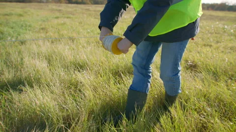 Employee using calibrated rope and plumm... | Stock Video | Pond5