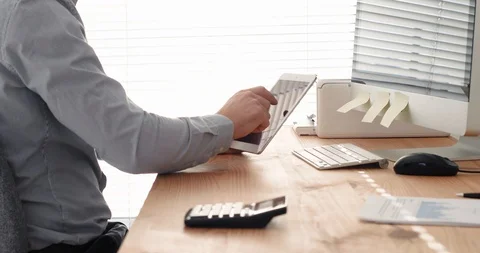 Employee using digital tablet computer in bright modern office workplace Stock Footage 124130715