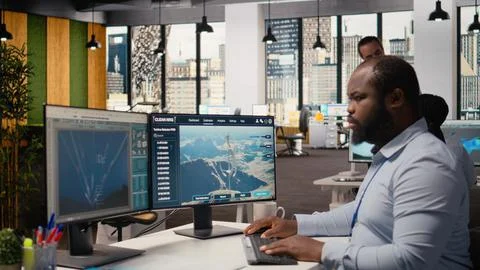 Employee using electric grid with wind farm layout modeling software Stock Photos