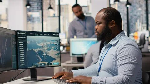 Employee using electric grid with wind farm layout modeling software Stock Photos