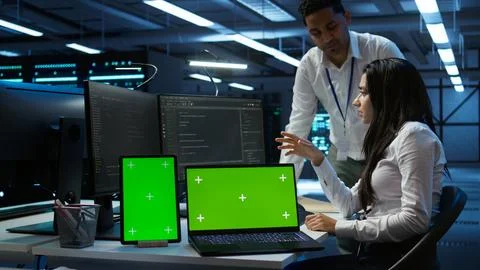 Employee using green screen devices in server farm used for automation 스톡 사진