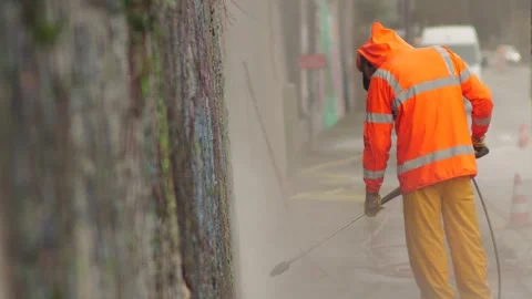 Employee Using High-Pressure Cleaner to Remove Wall Paint Stock Footage 348240763