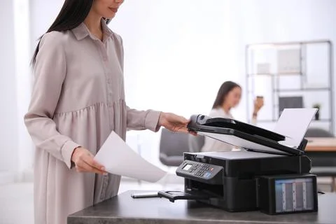 Employee using modern printer in office, closeup Stock Photos