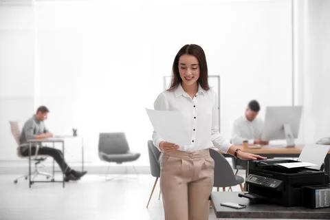 Employee using new modern printer in office Stock Photos