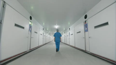 Employee walks down a corridor of a enterprise Видео 295599951