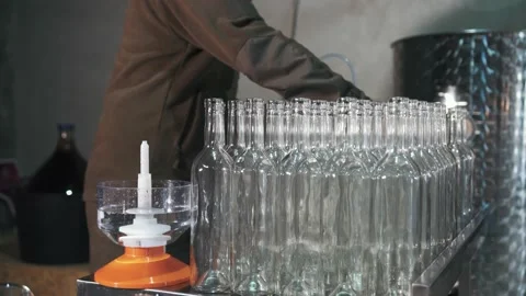An employee of a winery washes bottles Stock Footage 238354595