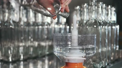 An employee of a winery washes bottles Stock Footage 238354598