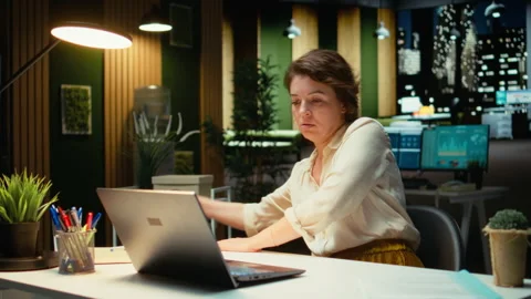 Employee works after hours organizing and scheduling tasks for corporate project Stock Footage 317965341