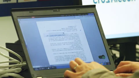Employee works with text of script on laptop at workplace Stock Footage 236578082